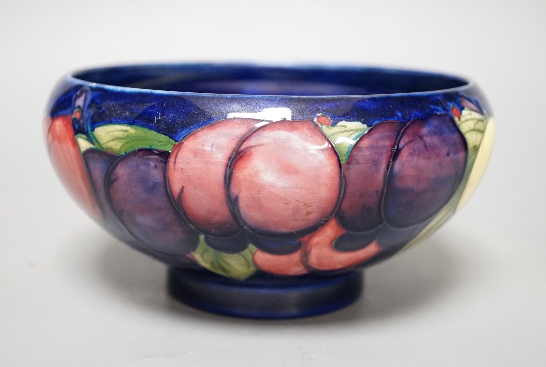 A Moorcroft Wisteria pattern bowl - 18cm wide